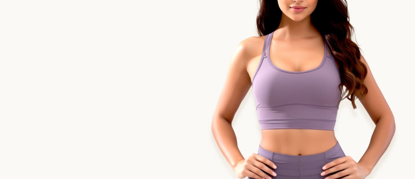 Woman in a purple athletic set standing with her hands on her hips