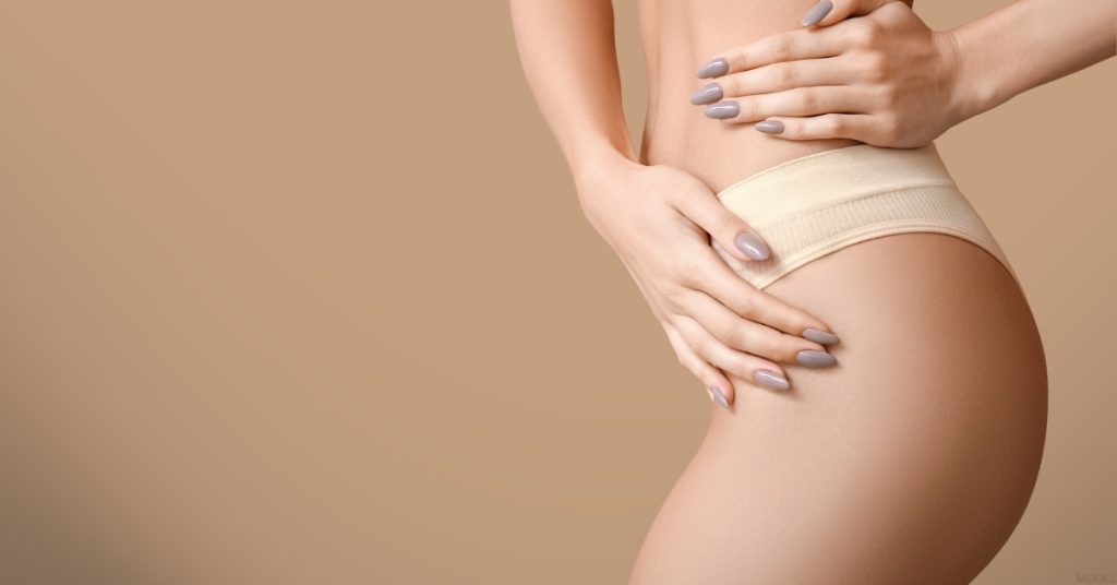 A woman with their hands on their hips (model)